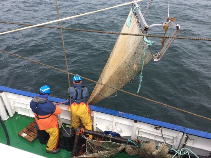 Picture of two research assistants and a beam trawl